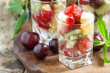 Salad from fruit and berries in glasses, selective focus