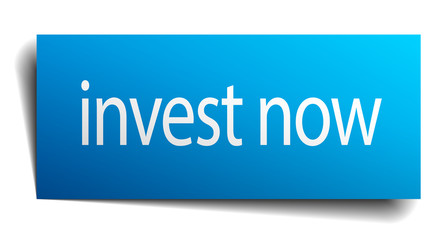 invest now blue paper sign on white background