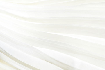 Detail of white pleated skirt. White cloth background pleated