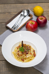 Dish of traditional spaghetti a la carbonara  with bacon , fork