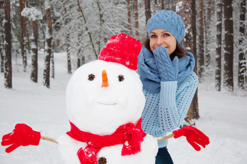 funny portrait of a girl with a snowman
