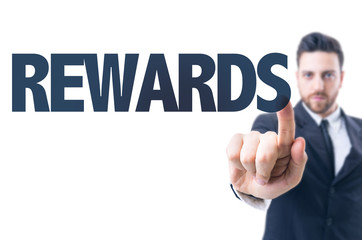 Business man pointing the text: Rewards