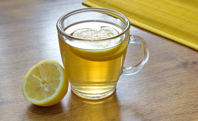 lemon tea with lemon pieces on the table