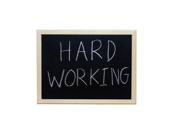 Obraz premium HARD WORKING written with white chalk on blackboard.