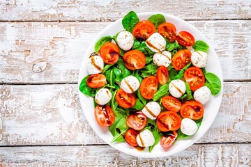 salad of mozzarella, cherry tomatoes and spinach with balsamic sauce