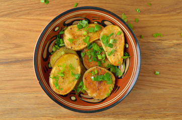 Oven-baked potatoes with herbs. Top view.