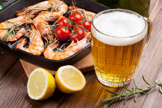 Grilled shrimps on frying pan and beer