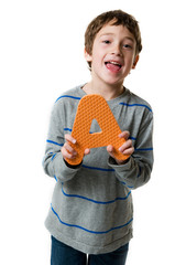 happy little boy holding up a letter A on a white background