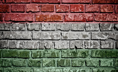 Hungary flag painted on old brick wall texture background 