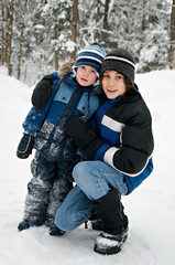 Fototapeta na wymiar two brothers outdoors on a snowy winter day