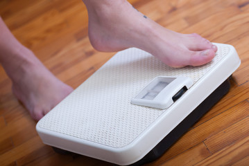 Womans feet and time for weight truth from a scale