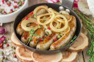 Fried sausages with spices and onions