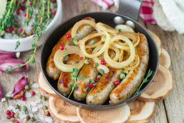 Fried sausages with spices and onions