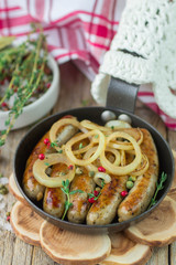 Fried sausages with spices and onions