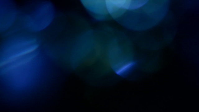 Blue, blurred, bokeh lights background. Abstract sparkles. Full HD seamless loop, 1080p.