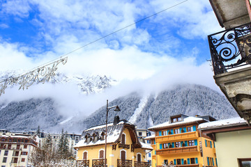 Chamonix town with snowy mountains on the background. Chamonix-Mont-Blanc was the site of the first Winter Olympics in 1924 and it's one of the oldest ski resorts in France.  - obrazy, fototapety, plakaty
