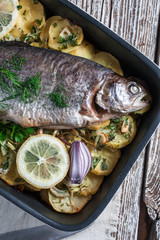 Baked trout with potatoes.