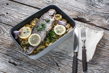 Baked trout with potatoes.