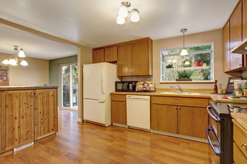 traditional kitchen with wood floor and cabinets.