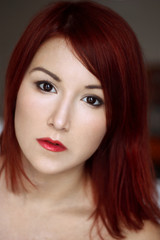 Fototapeta premium Young cute redhead woman with black eyes portrait