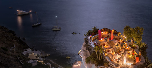 Terrace in front of the ocean. Restaurant with sea view at night - obrazy, fototapety, plakaty