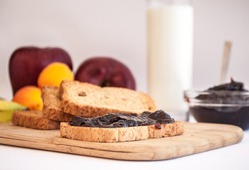 breakfast with sour cherry marmalade on toast with a glass of milk and frutis