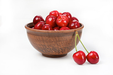 cherries in a bowl on a white background