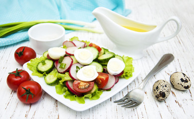Spring salad with tomato, cucumbers and radish