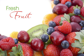 Fresh organic wholesome fruit on white wood table.