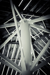 White iron pillars with wooden beams above.Black and white image.