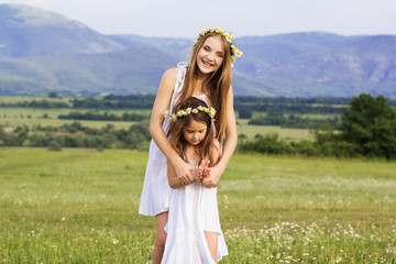 Cute girls at meadow with nice mountain view