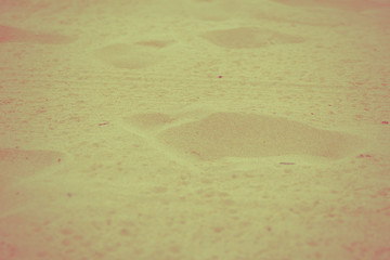 Footprints in the sand.
Vintage retro colors.
