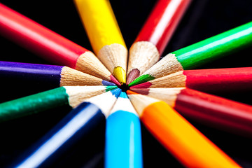 Macro of colored pencils in a circle.