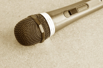 Vintage microphone on wooden background.