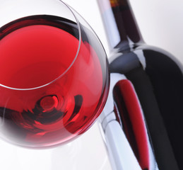 Wineglass with Reflection in Bottle