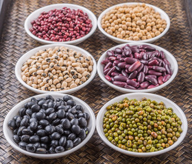 Fototapeta premium Beans variety in white bowl on in wicker tray