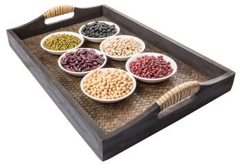 Beans variety in white bowl on in wicker tray