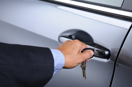 Man Putting Car Key into Door Lock