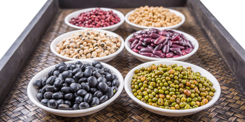 Beans variety in white bowl on in wicker tray