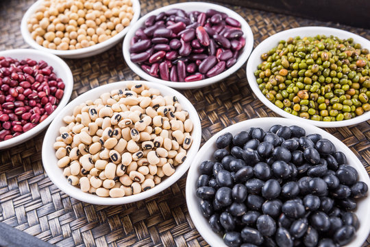 Beans variety in white bowl on in wicker tray