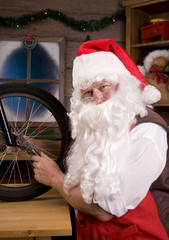 Santa Assembling Bicycle in Workshop