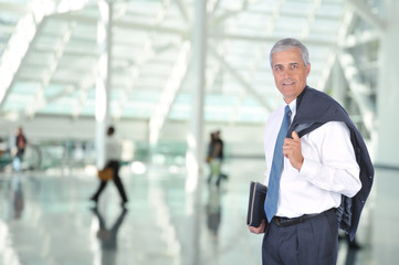 Fototapeta na wymiar Middle aged Business Traveler in Airport Concourse