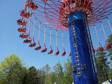 Aerial Swing Ride  At Theme Park With Trees