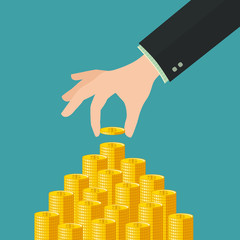 Hand placing a coin on money stack