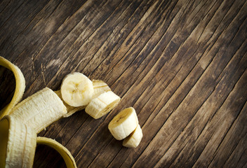 Ripe sliced banana on wooden background