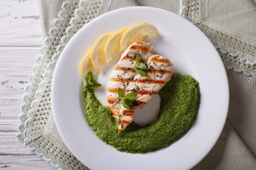 chicken and a side dish of green peas  horizontal top view close-up
