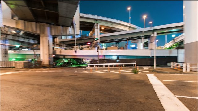 Motion (panning) time-lapse of traffic under the massive highway infrastructure in Osaka, Japan