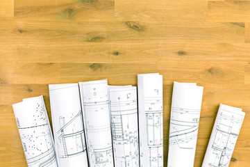 Fototapeta premium rolls of blueprints on wooden desk