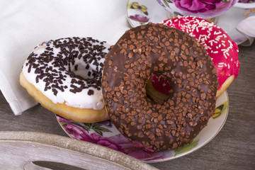 donuts and cup of coffee on wood background
