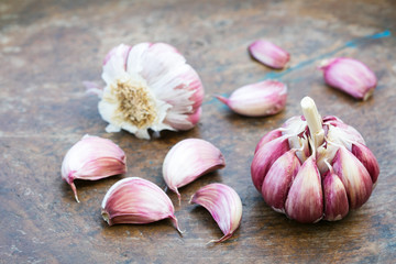 Garlic bulbs and cloves on wooden background